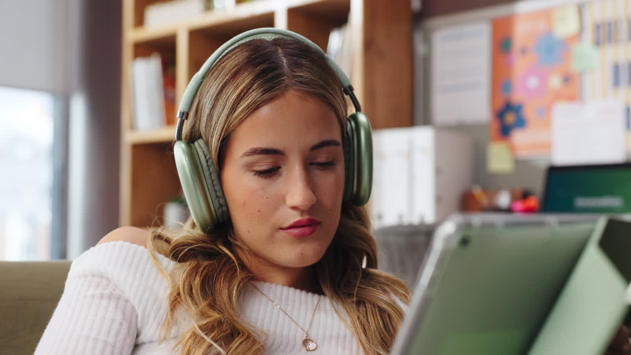 Woman using tablet with headphones