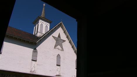 a white amish style barn in rural pennsylvania has a pentagram like star painted on it 1