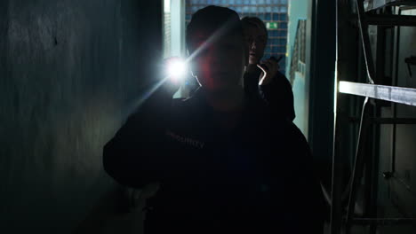 female safety guards with flashlight in a warehouse