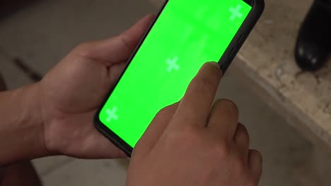 a smartphone user taping on a chroma screen