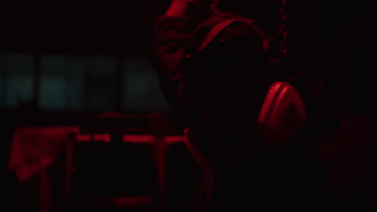 Person Wearing Gas Mask in Dark Red Light