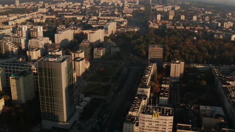 Forwards-fly-above-housing-estate-in-city.-Tilt-up-reveal-more-residential-buildings-in-morning-sun.-Warsaw,-Poland