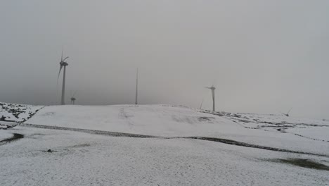Winterhang-Landschaft-Windkraftanlagen-Auf-Ländlichen-Hochland-Antenne-Push-In-Sicht-Kalt-Schneebedeckten-Talhang