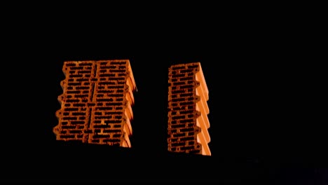 two hollow bricks on black background