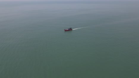 aerial shot of fishing boat in the middle of the sea fishing
