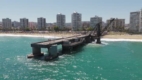 Aerial-View-Of-Vergara-Pier-In-Vina-Del-Mar-With-Hotel-And-Beach-Coastline-In-Background