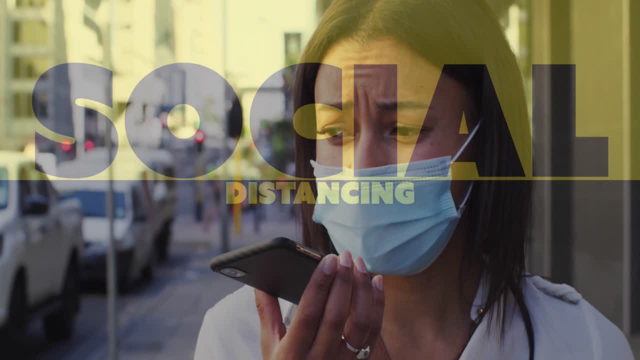 Social distancing text against woman wearing face mask talking on smartphone on the street