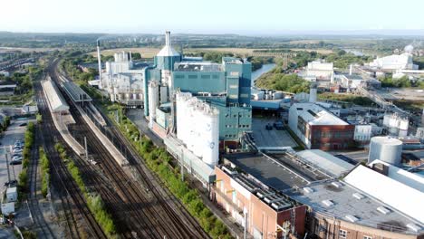 industrial chemical manufacturing factory next to warrington bank quay train tracks aerial view rising up