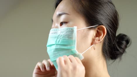 asian woman putting on face mask in slow motion