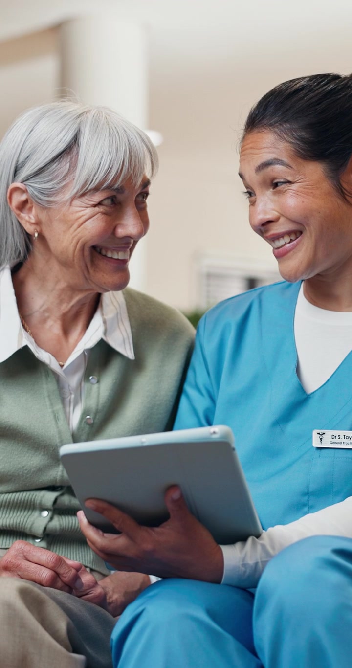 Nurse Showing Tablet to Senior Patient in Hospital