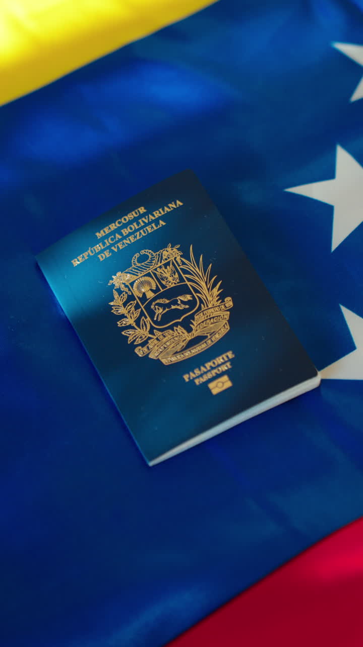 Venezuelský pas položený na státní vlajce. Koncept cestování, imigrace, mezinárodních vztahů a občanství