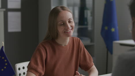 female visa applicant having interview with consular officer at eu embassy