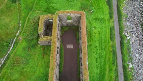 aerial zenithal shot of a drone descending inside a medieval cathedral in ruins