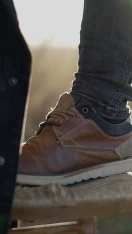 close-up of a person's foot and shoe in warm sunlight
