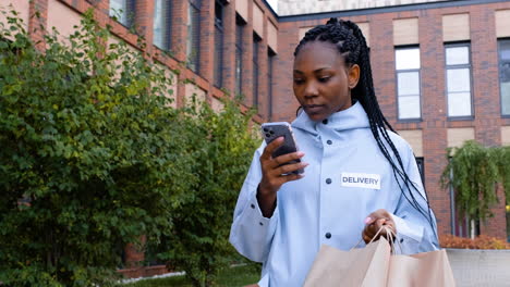 Young-woman-holding-paper-bags-on-the-street