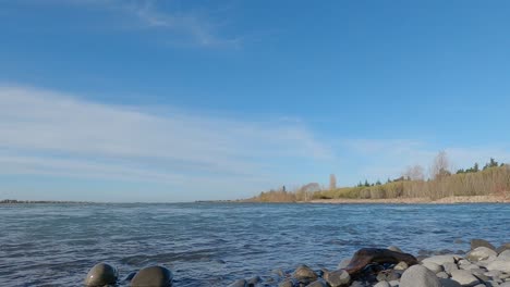 fast flowing river late afternoon on winter's day - waimakariri river, new zealand