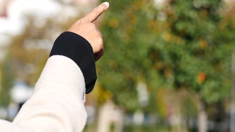 woman pointing to something outdoors