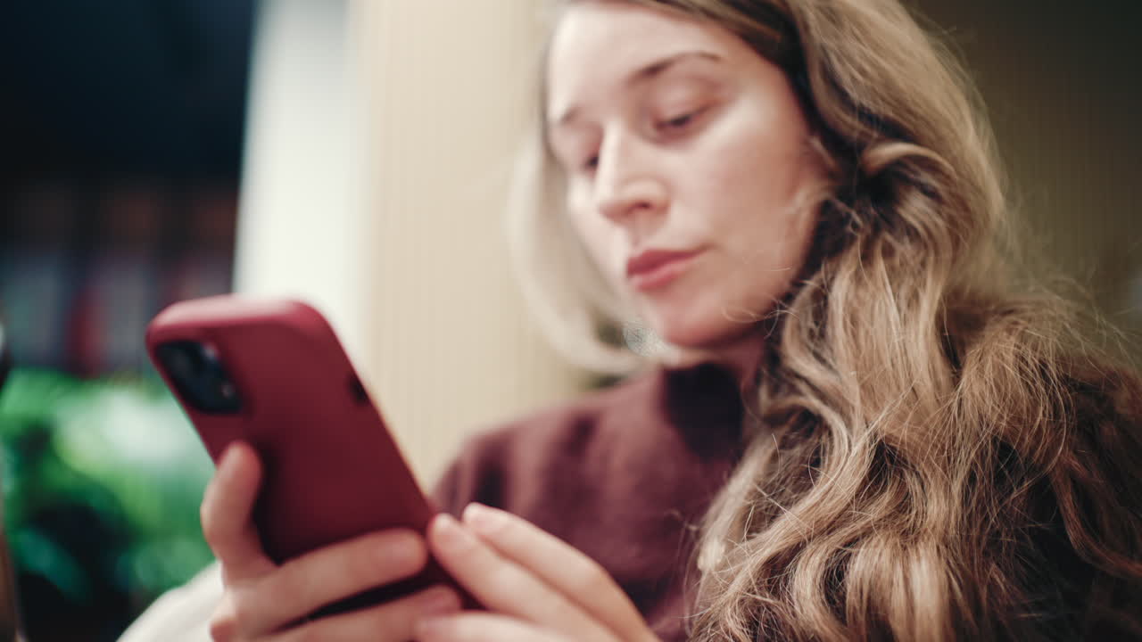 Close up of a woman's hands holding and using a smartphone