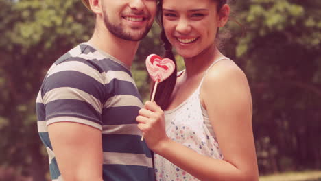 in slow motion cute couple sharing a lollipop