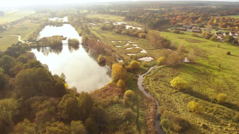 aerial view of nunery lake and water canals supplying water to the neighbouring agricultural fields, beside a small town in thetford norfolk, uk