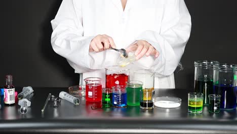 scientist conducting experiment with colorful liquids