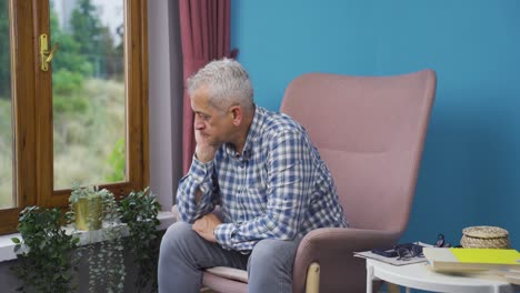 Worried-and-nervous-man-at-home-watching-outside.