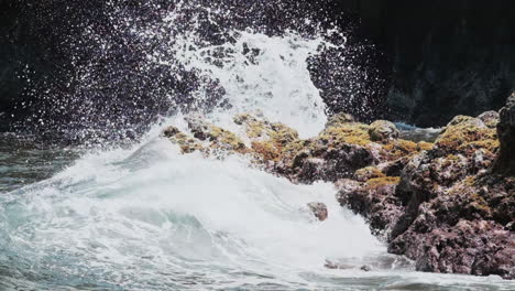 Powerful-deep-blue-Pacific-Ocean-waves-crash-against-rocky-Hawaiian-shoreline