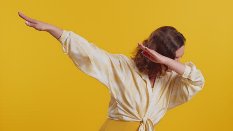 cheerful woman having fun dancing moving to rhythm dabbing raising hands making dub dance gesture
