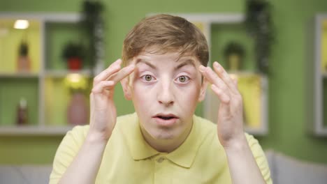 close-up of young man looking at camera, looking at his body and face.