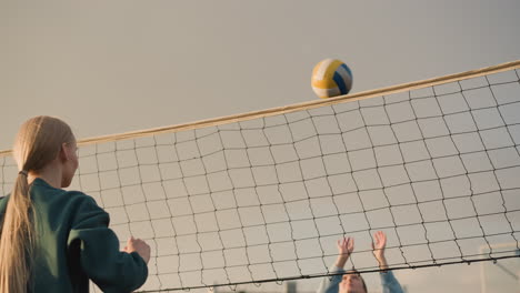 volleyball player competes in outdoor match with sunlight reflecting on net, creating warm glow, hands reaching for ball in action-packed game, with blue sky and blurred background