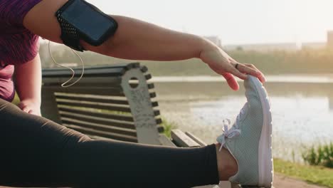 woman stretching her legs before jogging