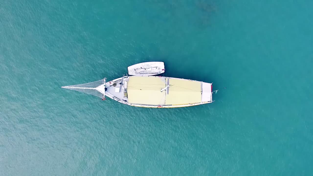 바다 한가운데에 있는 큰 항해 보트의 위에서 내려다보는 모습 그리고  ⁇ 고 뜨거운 여름날에 모든 문명으로부터 멀리 떨어져 있는 모습