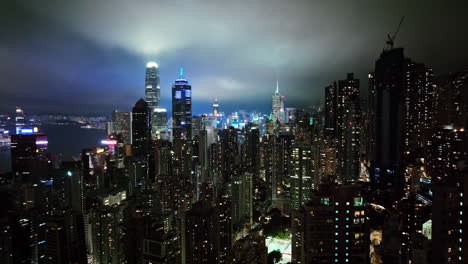 a view of a city at night from the top of a skyscraper