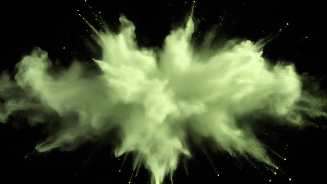 Explosion of Light Green Powder Against Black Background