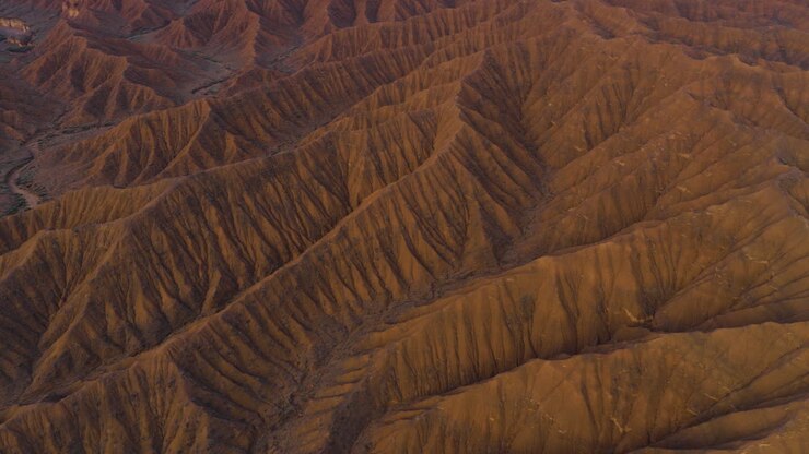 Unique Geological Formations Of Ak-Sai Canyon (Valley of Forgotten Rivers) During Sunrise In Kyrgyzstan, Central Asia. Aerial Shot