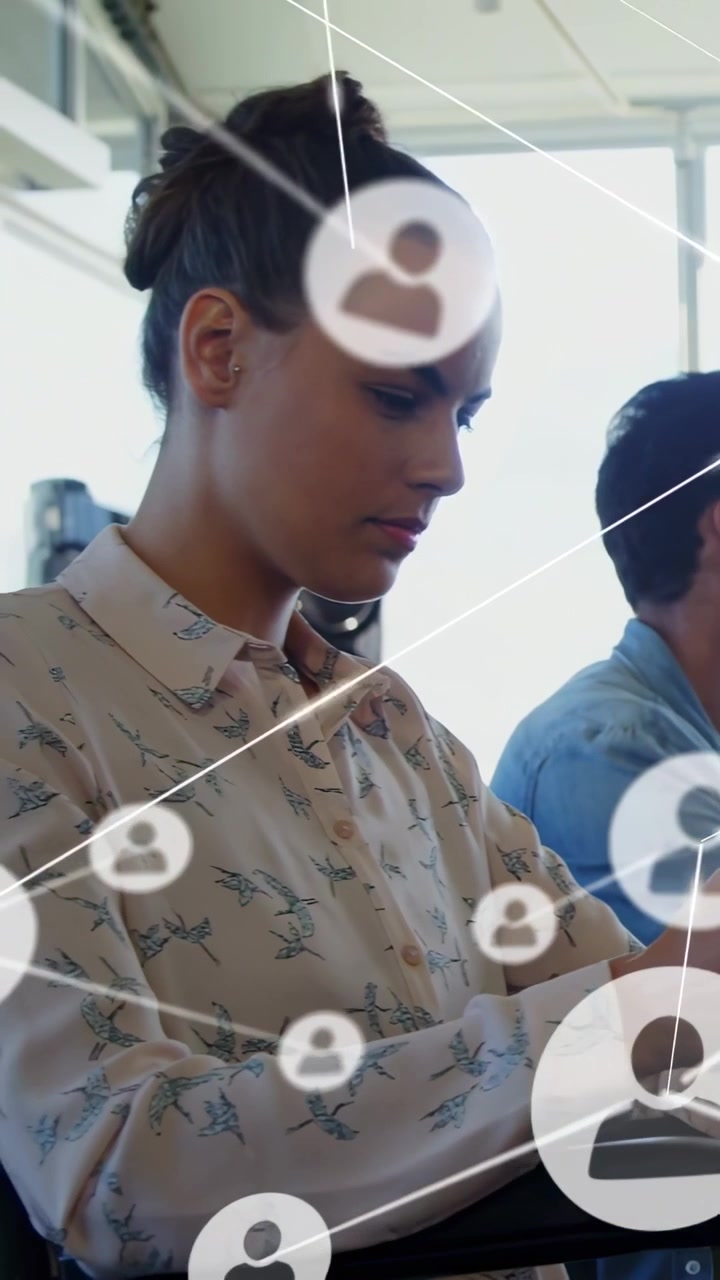 Vertical video: Front woman tapping tablet starting links as camera panning showing tech network