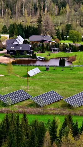 luxury resort estate with water pond and solar panel field, aerial vertical view