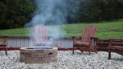 Seamless-loop-of-a-fire-pit-surrounded-by-wooden-rocking-chairs,-creating-a-cozy-backyard-scene