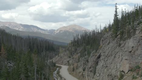 Aerial-rising-over-road-with-mountain-in-background-in-Colorado