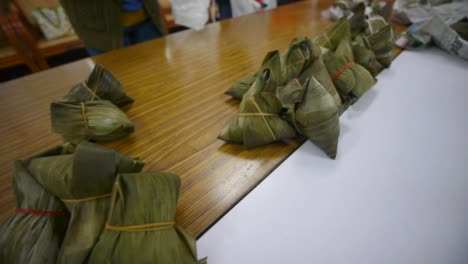 Asian-rice-triangles-wrapped-in-leaf-arranged-into-groups-with-camera-sliding-in-parallel