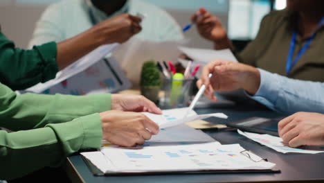 close up of diverse specialists evaluating data numbers on archived files