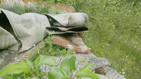 Rotating-shot-of-rusty-metal-scrap-waste-pollution-in-the-forest-wilderness