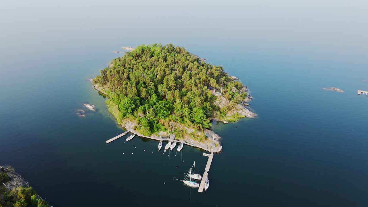 Drone of Stockholm Archipelago island - vibrant greenery and tranquil harbor