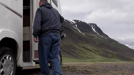 Man-walking-to-RV-in-Iceland-with-Mountain