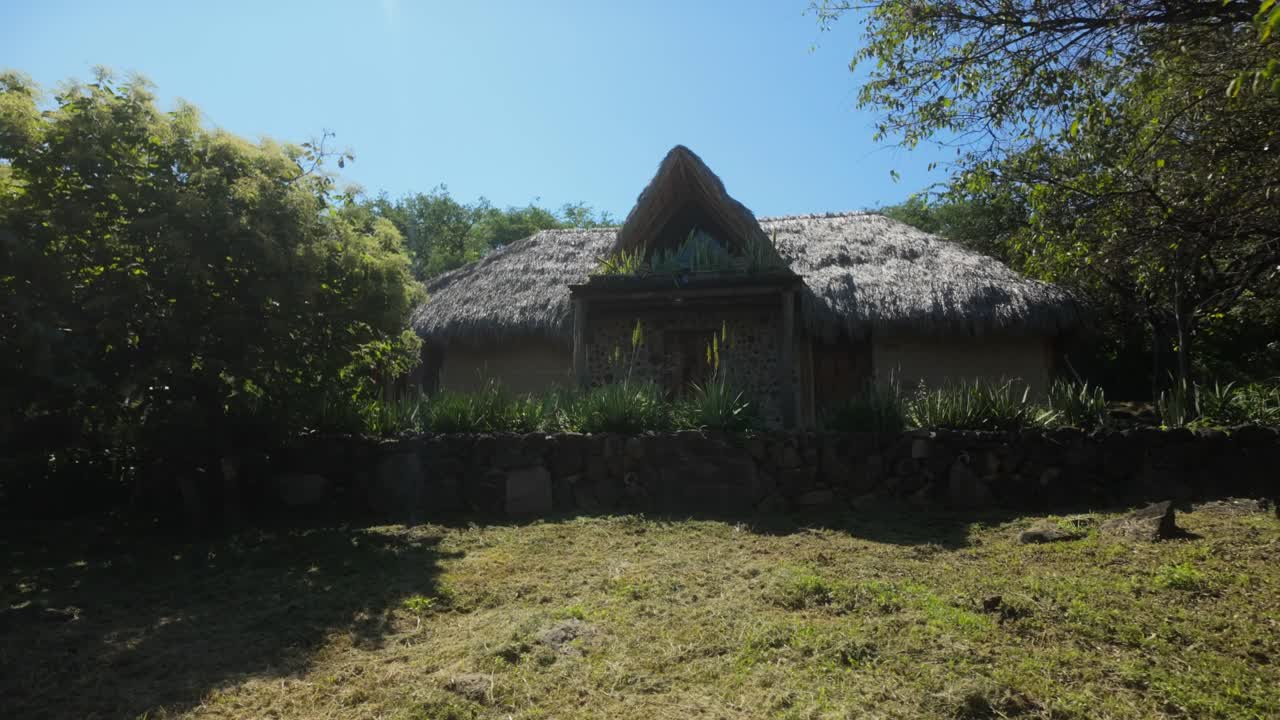 Rustic Cob house with thatched roof in eco-friendly natural environment