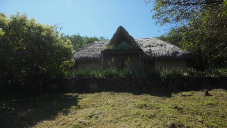 rustic cob house with thatched roof in eco-friendly natural environment