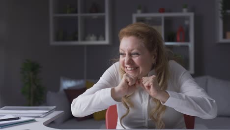 business woman working in home office rejoicing, winning, victory.