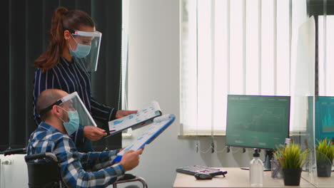 people with protective mask in new normal office making strategy