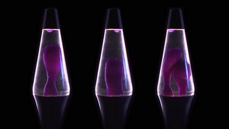 three purple lava lamps on a black background