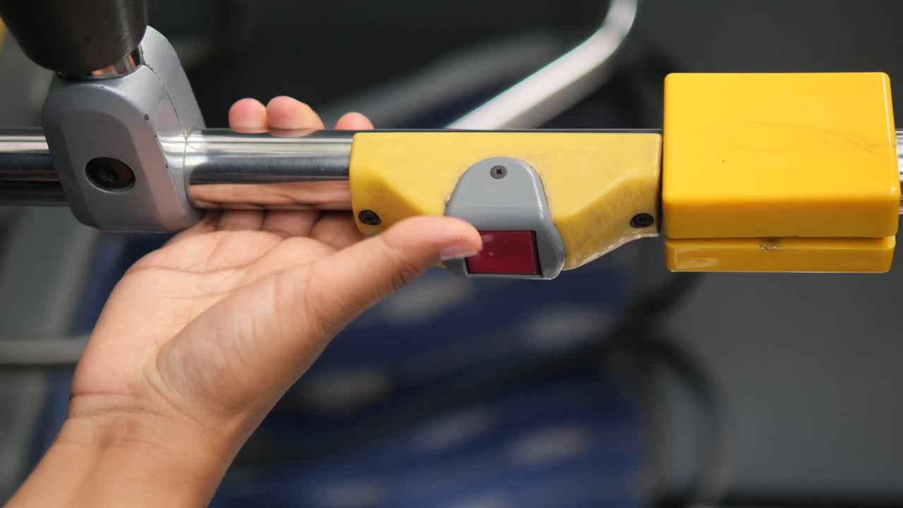 Hand pressing bus stop button